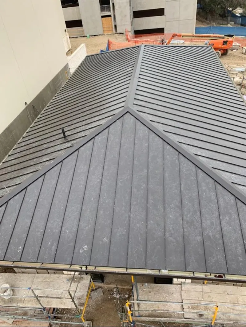 Commercial metal roof construction with crane equipment in Louisville